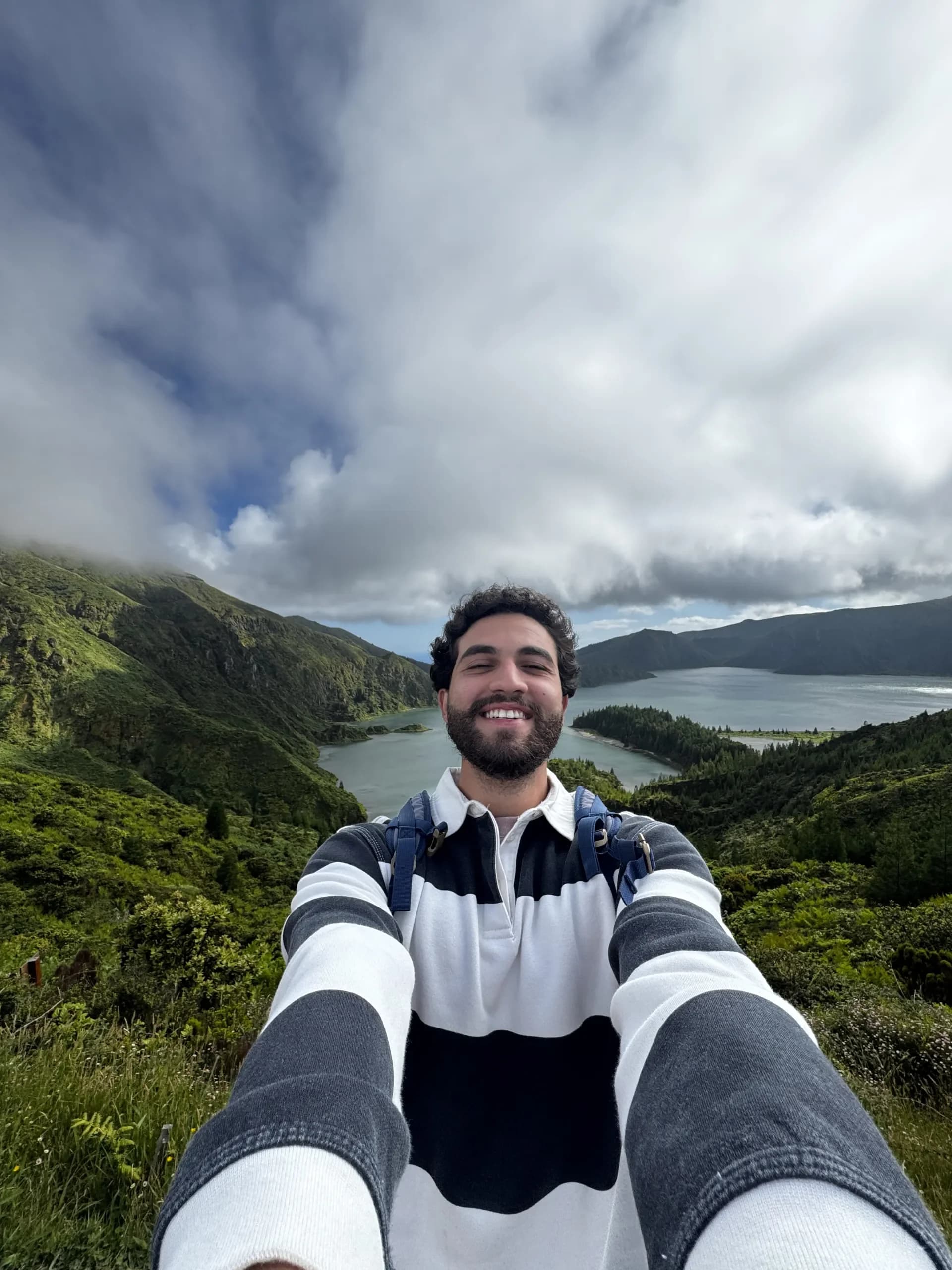 Hazem smiling on a trail above the twin lakes of Sete Cidades, Azores